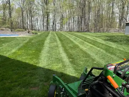 Striped residential lawn after mowing service