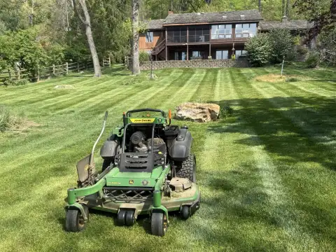 Freshly mowed residential lawn with clean stripes and curb appeal