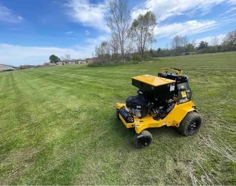 Aeration and overseeding service in progress on a residential lawn