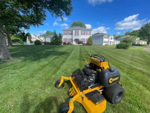Freshly mowed lawn with crisp striping in front of a home